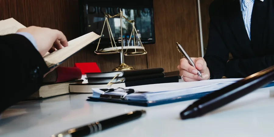 Solicitors at work with the scales of justice on the desk