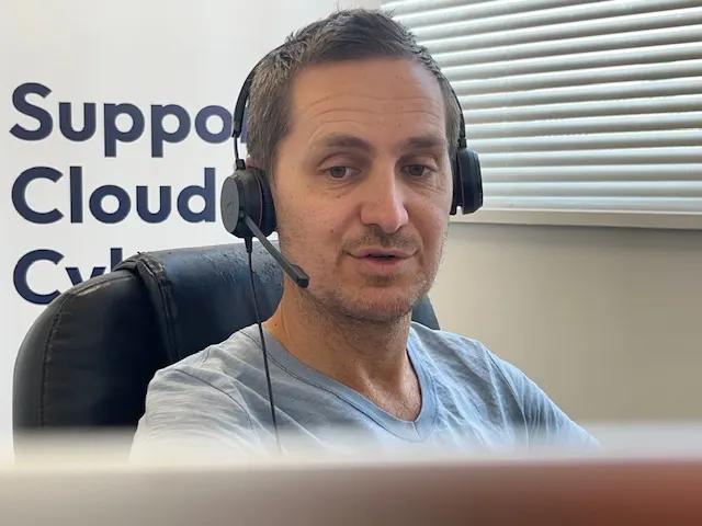 A Technologylab support engineer taking a call on a headset